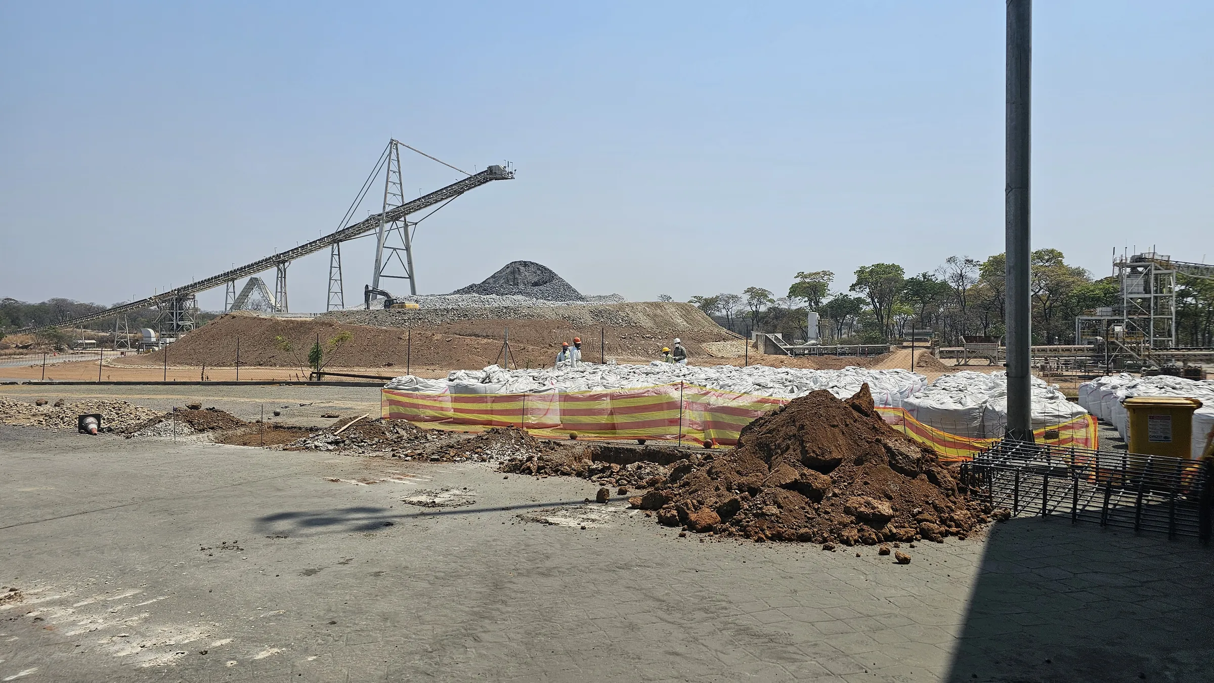 An active mine site with workers in protective equipment